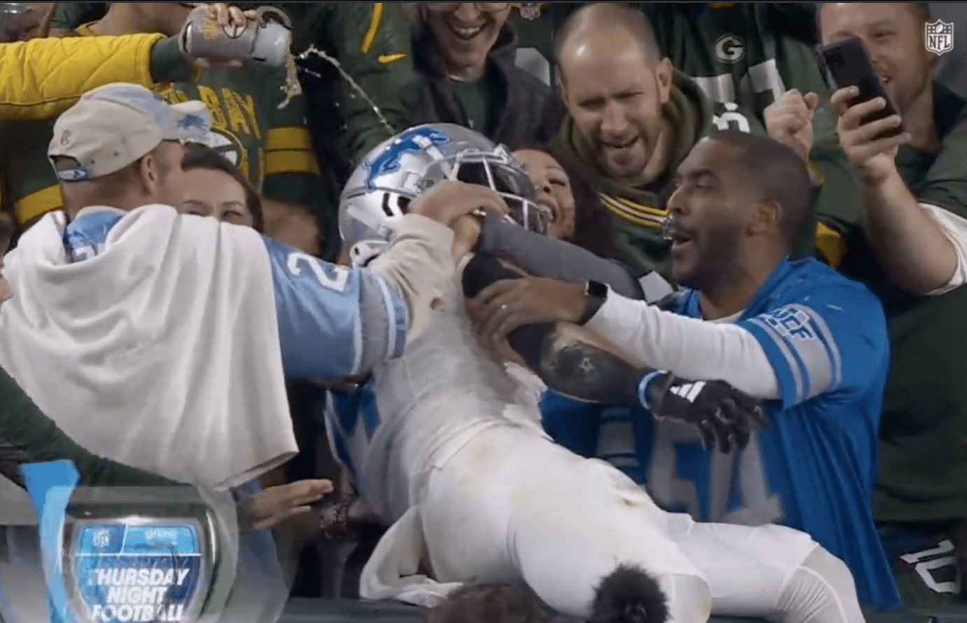 Packers fan pours beer on Amon-Ra St. Brown