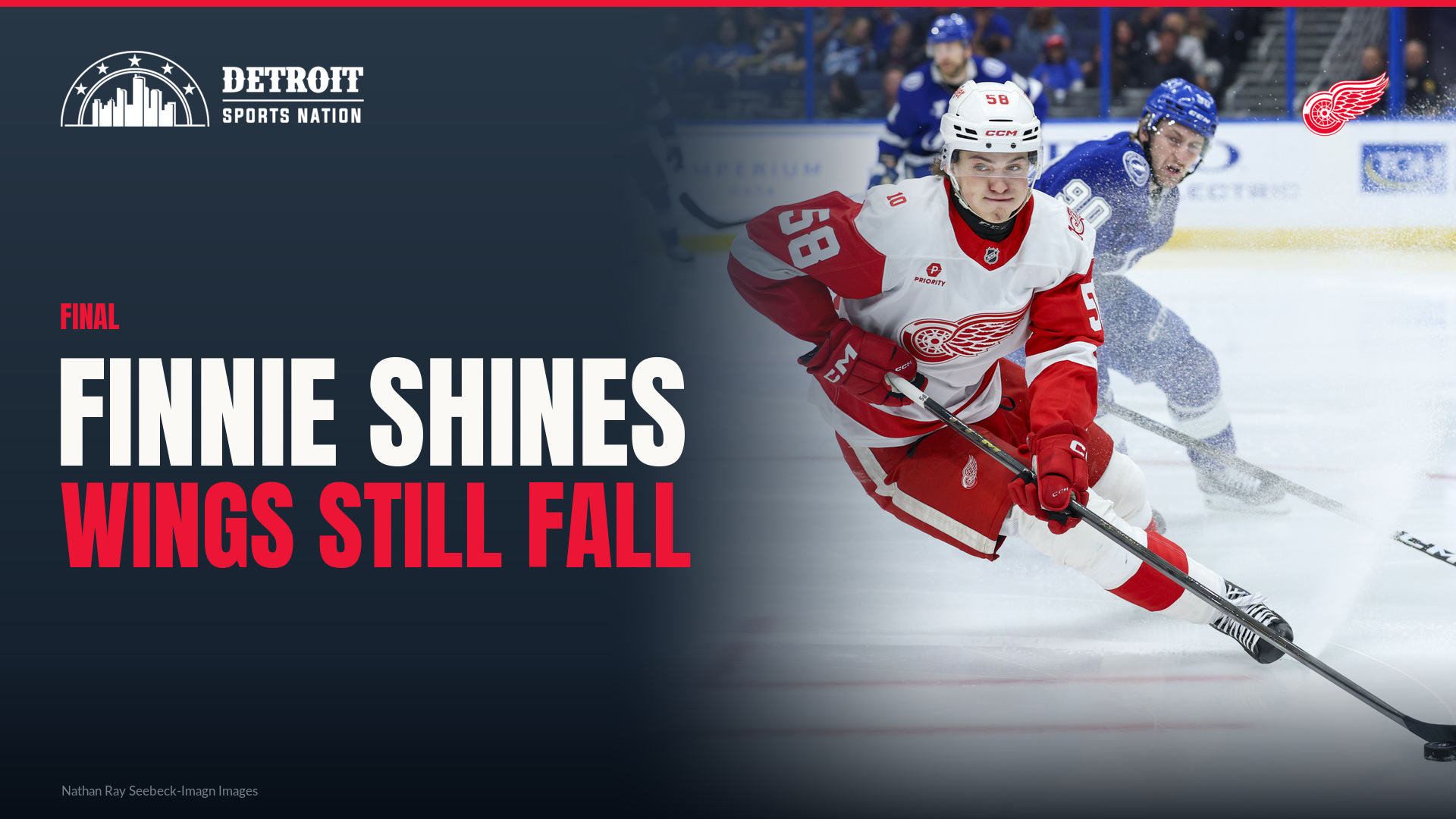 Emmitt Finnie of the Detroit Red Wings skates with the puck